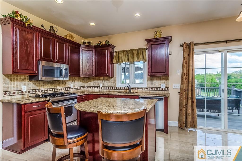 437 Vanderveer Road Raritan, NJ 08869 - Photo 4 of 25 a kitchen with stainless steel appliances granite countertop a stove a sink and a refrigerator