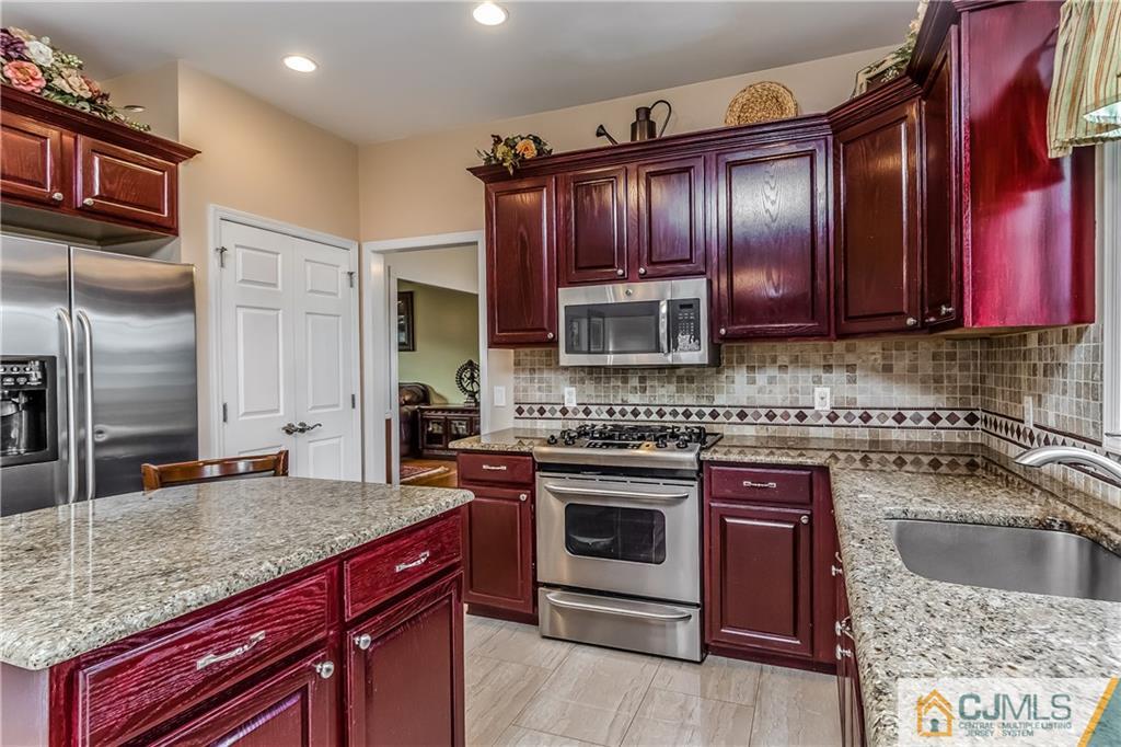 437 Vanderveer Road Raritan, NJ 08869 - Photo 5 of 25 a kitchen with stainless steel appliances granite countertop a stove sink microwave and refrigerator