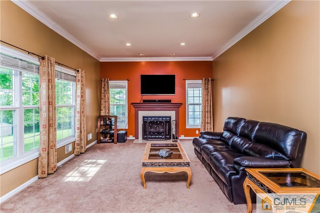 437 Vanderveer Road Raritan, NJ 08869 - Photo 7 of 25 a living room with furniture a fireplace and a flat screen tv