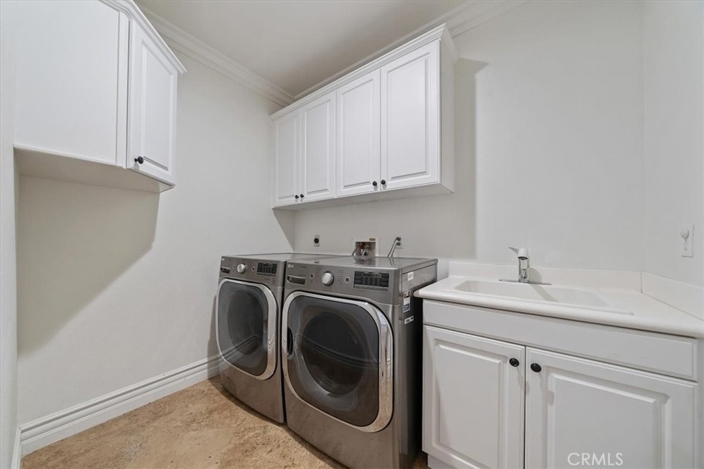 9 Waltham Road Ladera Ranch, CA 92694 - Photo 28 of 68 a utility room with sink dryer and washer