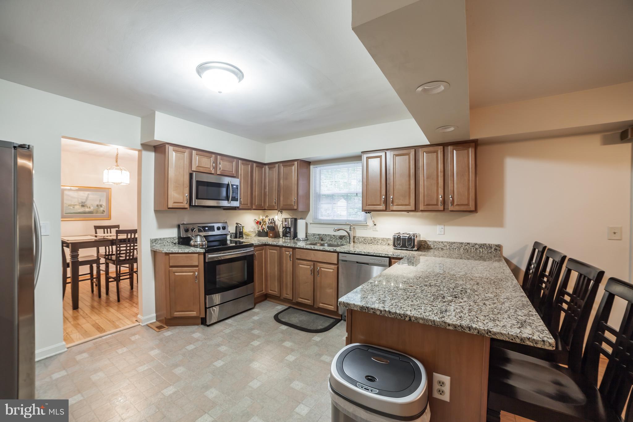 705 Mesquite Road Severn, MD 21144 - Photo 6 of 30 open kitchen had granite counters and breakfast ba