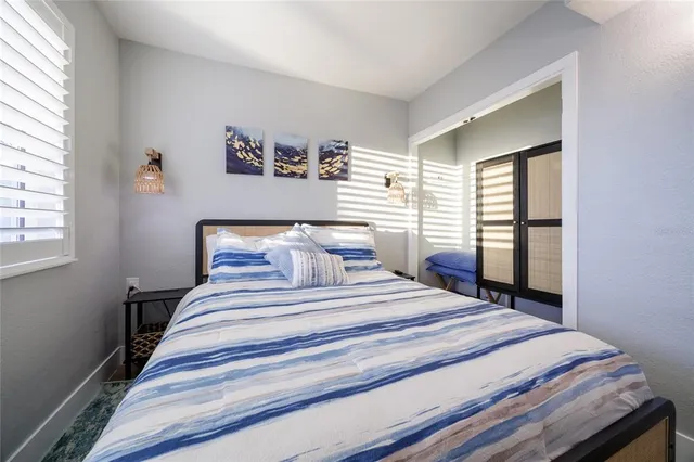 a bedroom with a large bed and a large window