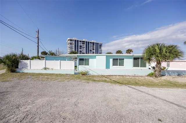 a house that has a tree in front of it