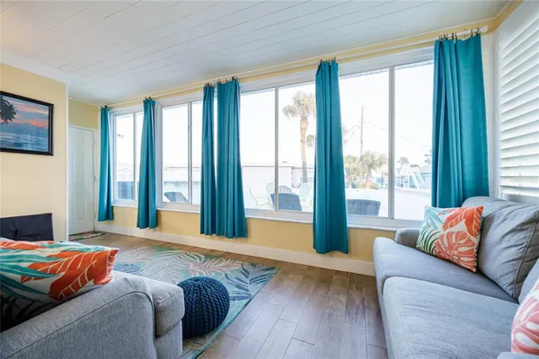 a wooden bench sitting in a room next to a window