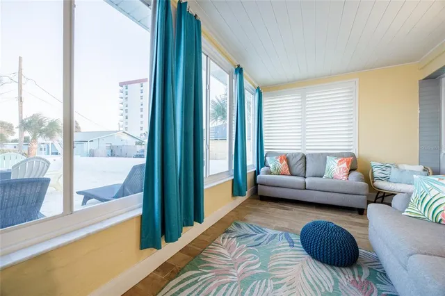 a wooden bench sitting in a room next to a window