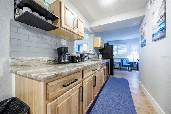 a bedroom with a bed wooden floor and window