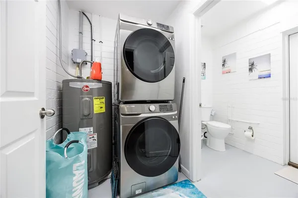 a large bed sitting in a bedroom next to a window