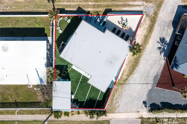 a building outdoor space with patio furniture and potted plants