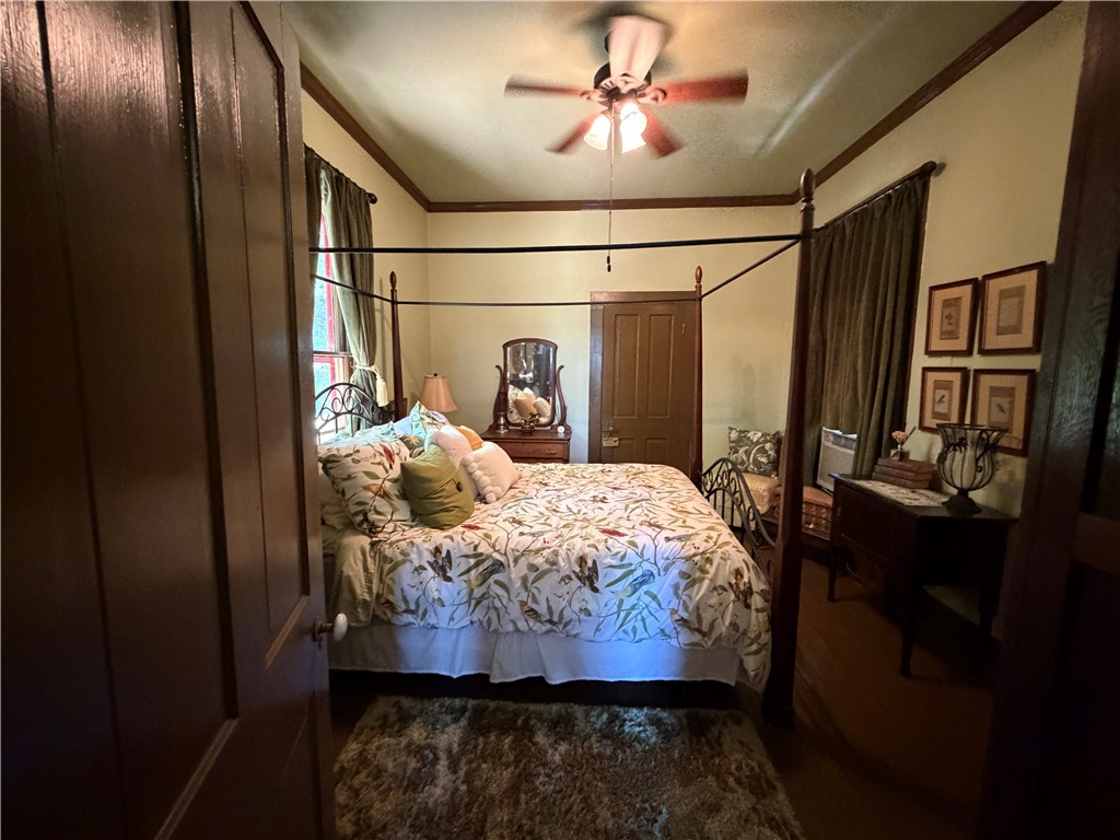 1100 Maple Calvert, TX 77837 - Photo 19 of 32 a bedroom with a bed and wooden floor