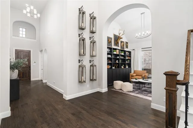 a spacious bedroom with a bed window and flat screen tv