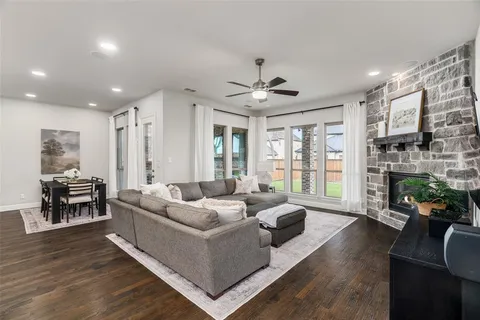 a living room with fireplace furniture and a wooden floor