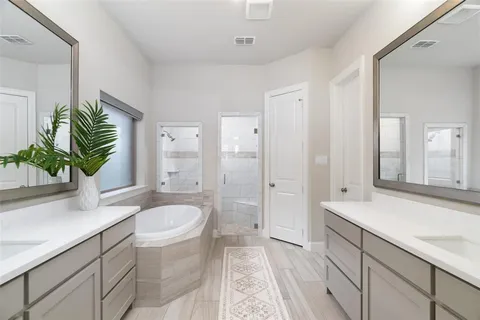 a spacious bathroom with a granite countertop sink a toilet a mirror and shower
