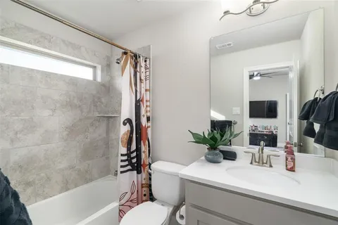 a bathroom with a sink a mirror a bathtub and shower