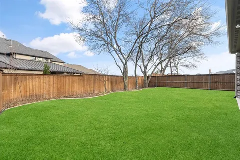 a view of yard with trees in the background