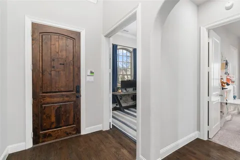a view of a hallway with wooden floor and closet