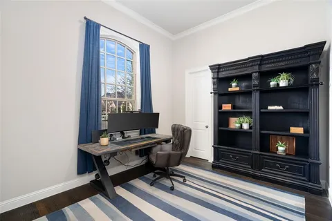 a view of a workspace with furniture and bookshelf
