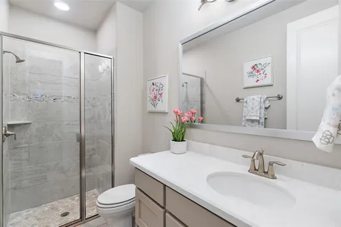 a bathroom with a sink toilet and shower