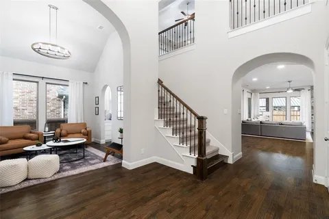 a view of an entryway with wooden floor and couches