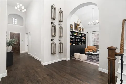 a view of a hallway with wooden floor and windows