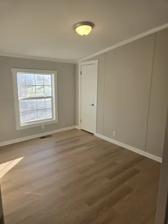 an empty room with windows and closet
