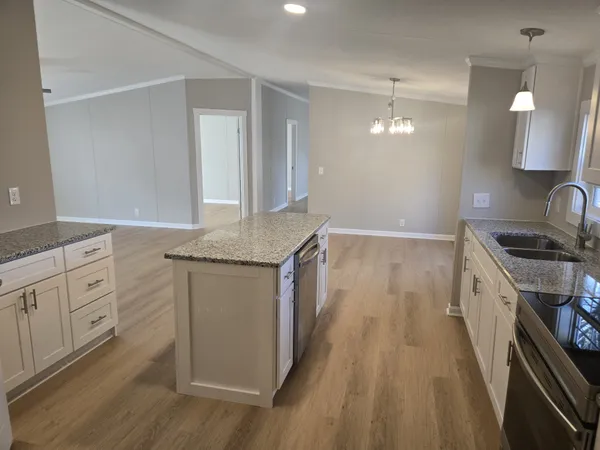 a kitchen with white cabinets appliances and a sink