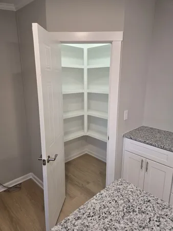 a view of walk in closet with empty racks