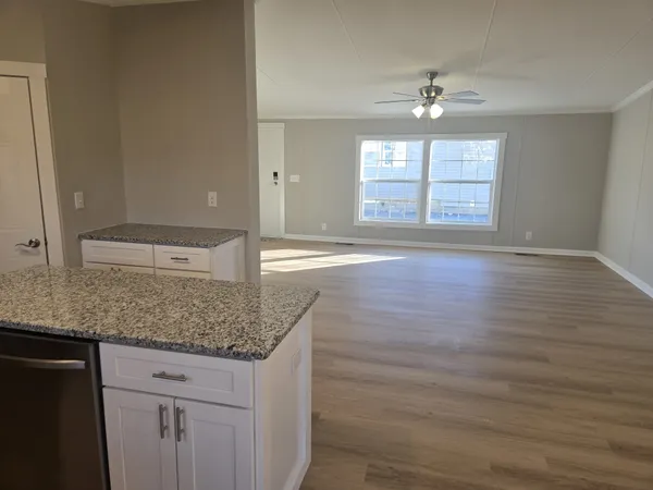 a view of kitchen with granite countertop cabinets and wooden floor