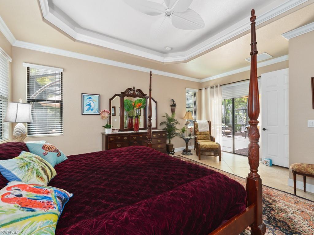 9522 Piacere Way Naples, FL 34113 - Photo 21 of 48 Tiled bedroom with ornamental molding, a raised ceiling, ceiling fan, and access to exterior