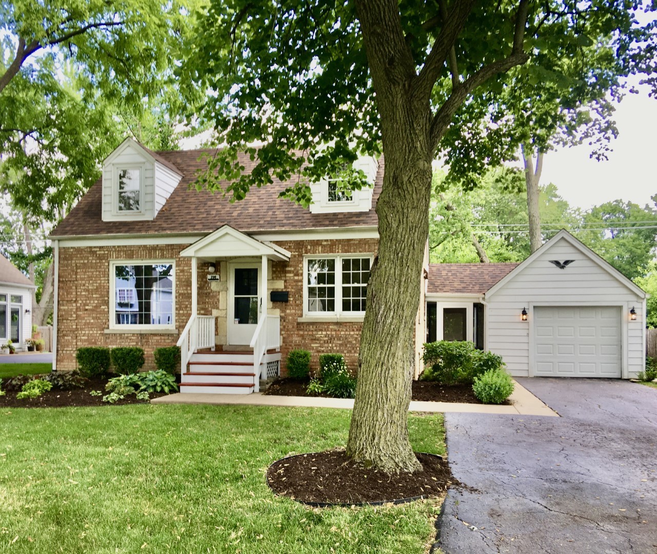a front view of a house with a yard and porch