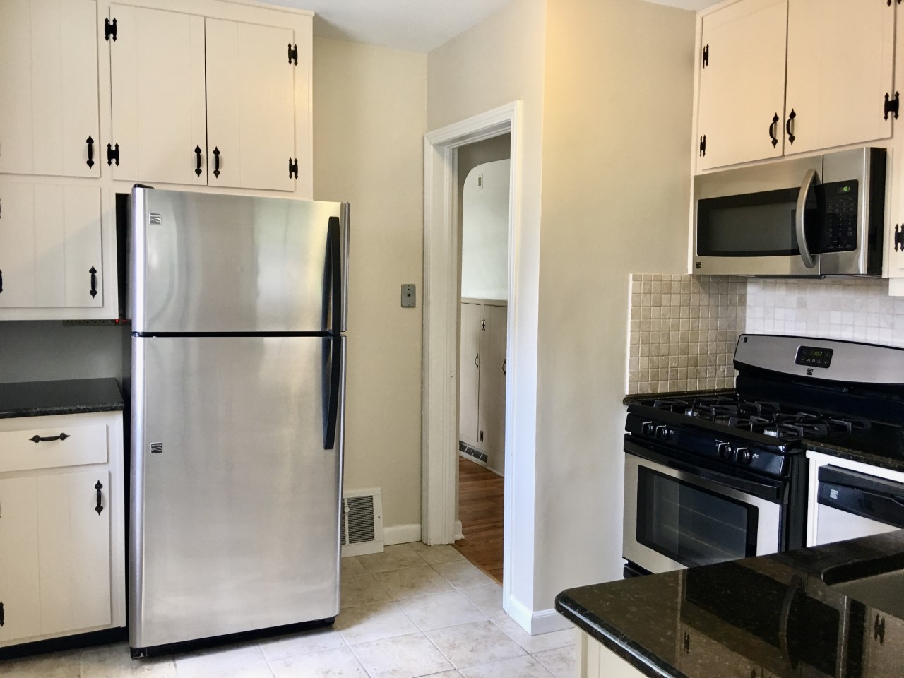719 North County Line Road Hinsdale, IL 60521 - Photo 6 of 12 a kitchen with stainless steel appliances granite countertop a refrigerator and a stove top oven