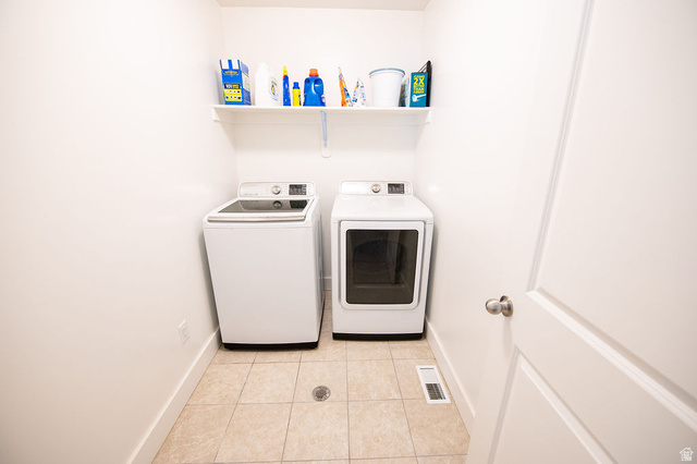 384 Ropelato Drive Nibley, UT 84321 - Photo 17 of 25 Laundry area featuring light tile patterned flooring and washing machine and dryer