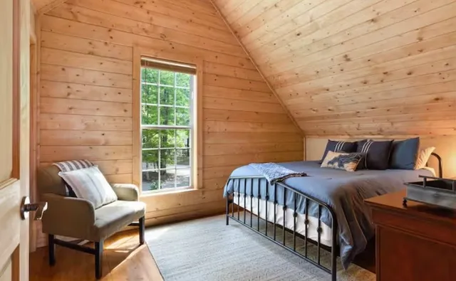 a bedroom with a bed and a window