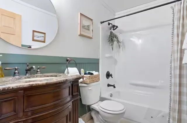 a bathroom with a granite countertop sink toilet and shower