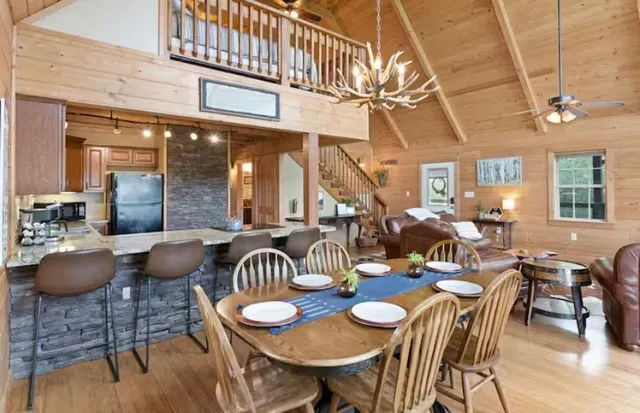 a dining room with furniture and wooden floor