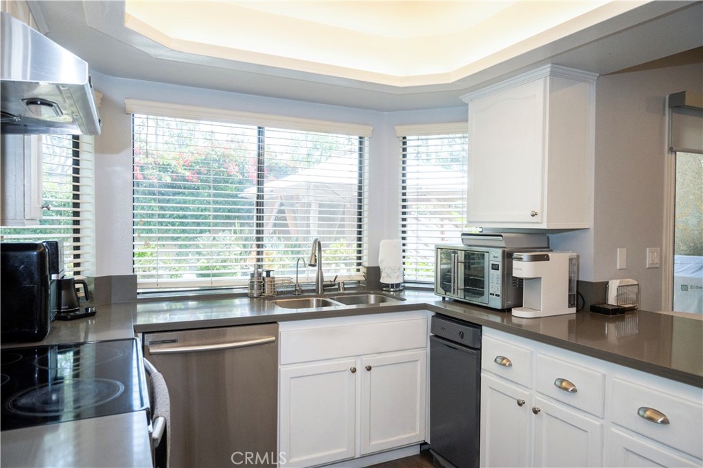 1320 Zeus West Covina, CA 91790 - Photo 11 of 39 a kitchen with granite countertop a sink a counter space appliances and cabinets