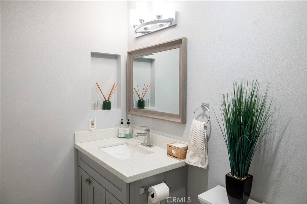 1320 Zeus West Covina, CA 91790 - Photo 25 of 39 a bathroom with a sink a mirror and a potted plant