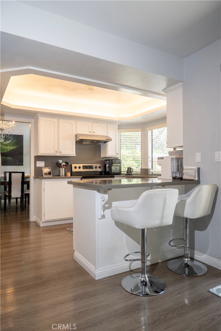 1320 Zeus West Covina, CA 91790 - Photo 10 of 39 a kitchen with stainless steel appliances kitchen island granite countertop a stove a sink and a refrigerator