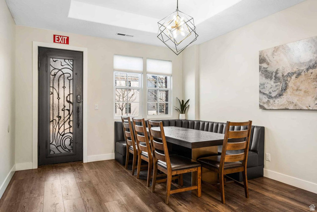 4311 Canterbury Road, Unit F2 Hurricane, UT 84737 - Photo 4 of 18 Dining area featuring wood-finish flooring, built-in window seating, and a decorative frosted glass entry door