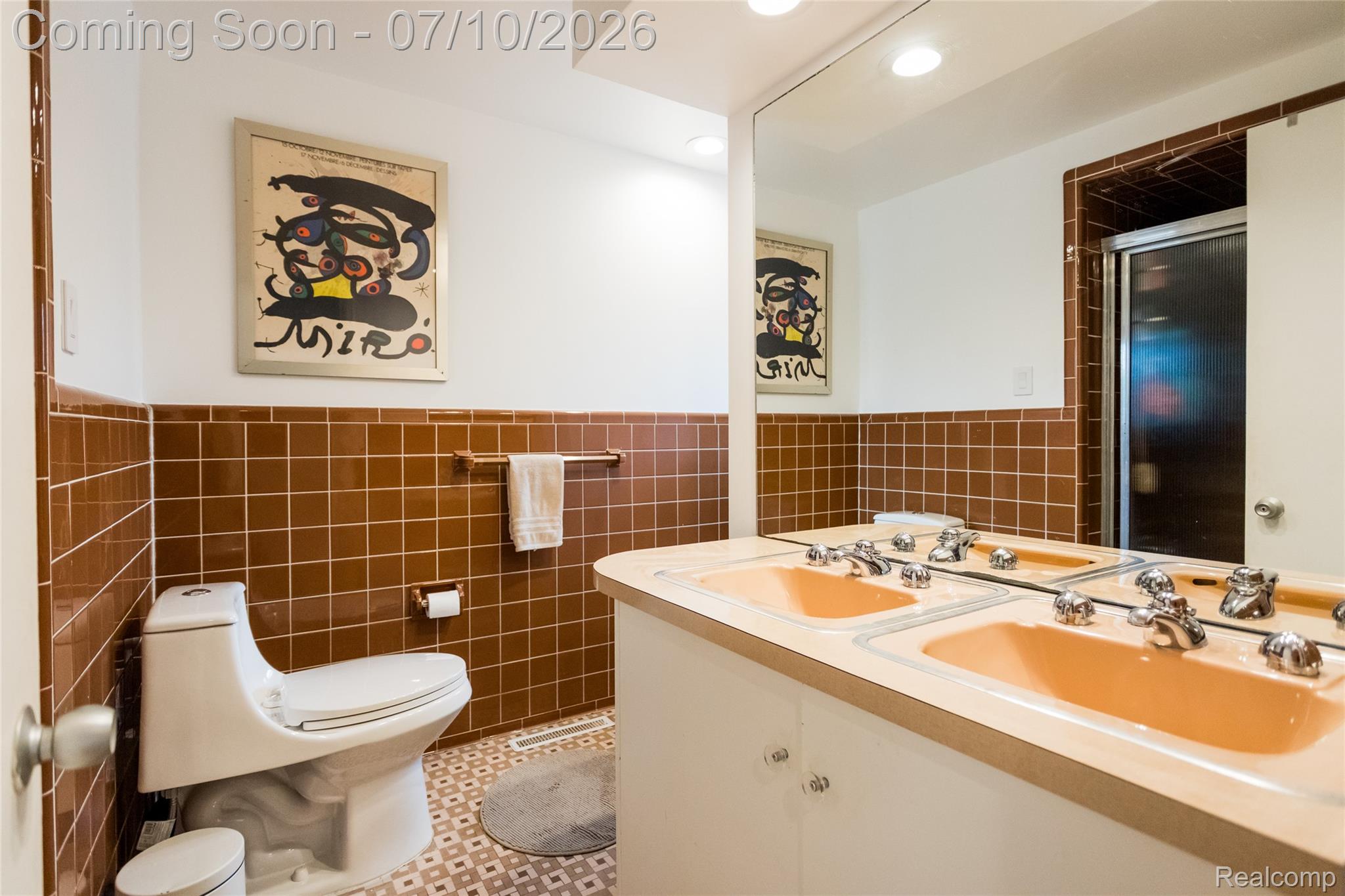 600 Middlesex Road Grosse Pointe, MI 48230 - Photo 23 of 43 Bathroom featuring a dual vanity with peach-toned sinks, chrome fixtures, and a large wall-mounted mirror