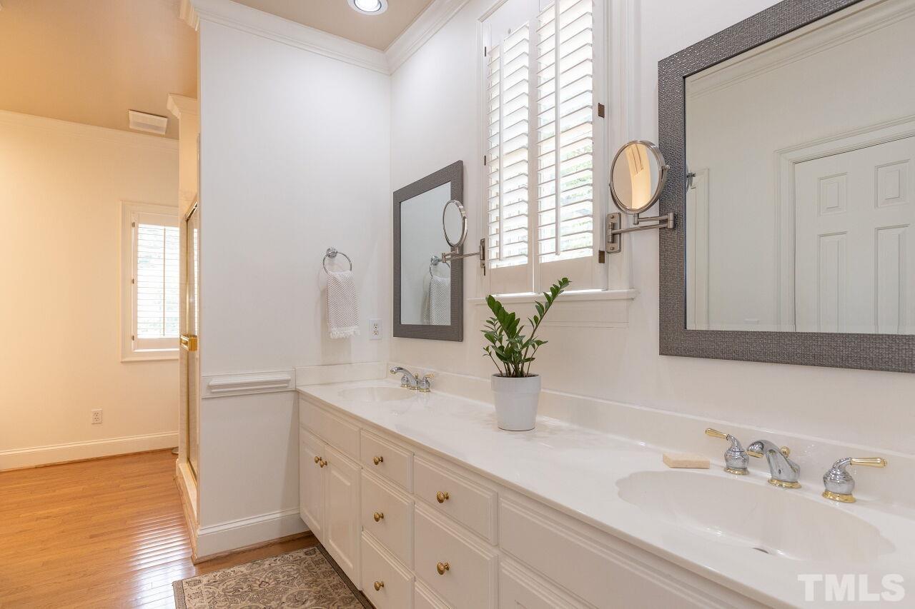 107 Quarter Path Cary, NC 27518 - Photo 15 of 29 a bathroom with a double vanity sink and a mirror