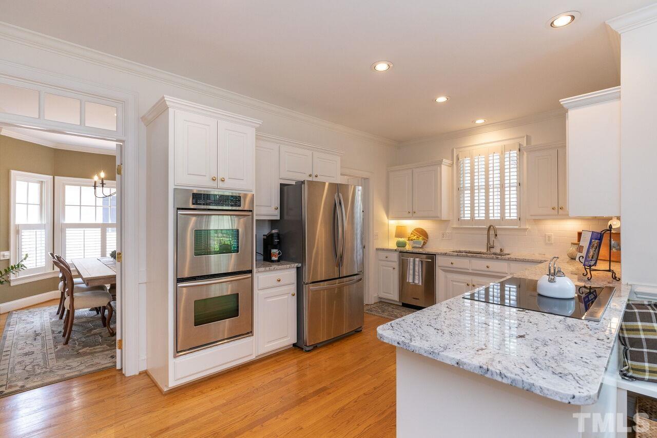 107 Quarter Path Cary, NC 27518 - Photo 8 of 29 a kitchen with stainless steel appliances granite countertop a refrigerator a stove and a sink