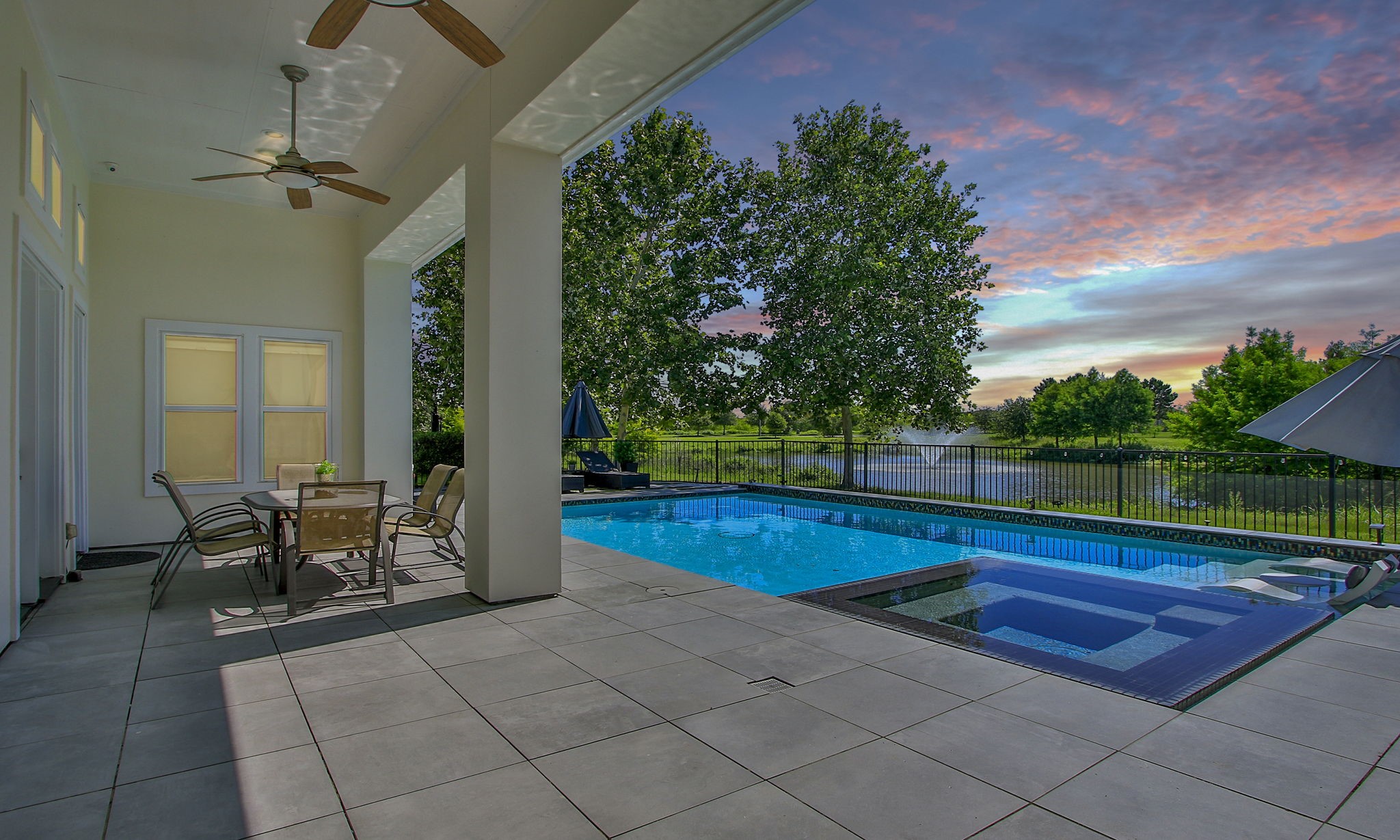 28518 Hoffman Spring Lane Fulshear, TX 77441 - Photo 41 of 50 Beautiful sunset over the lake from your private outdoor oasis. The outdoor surround system enhances your entertainment experience.
