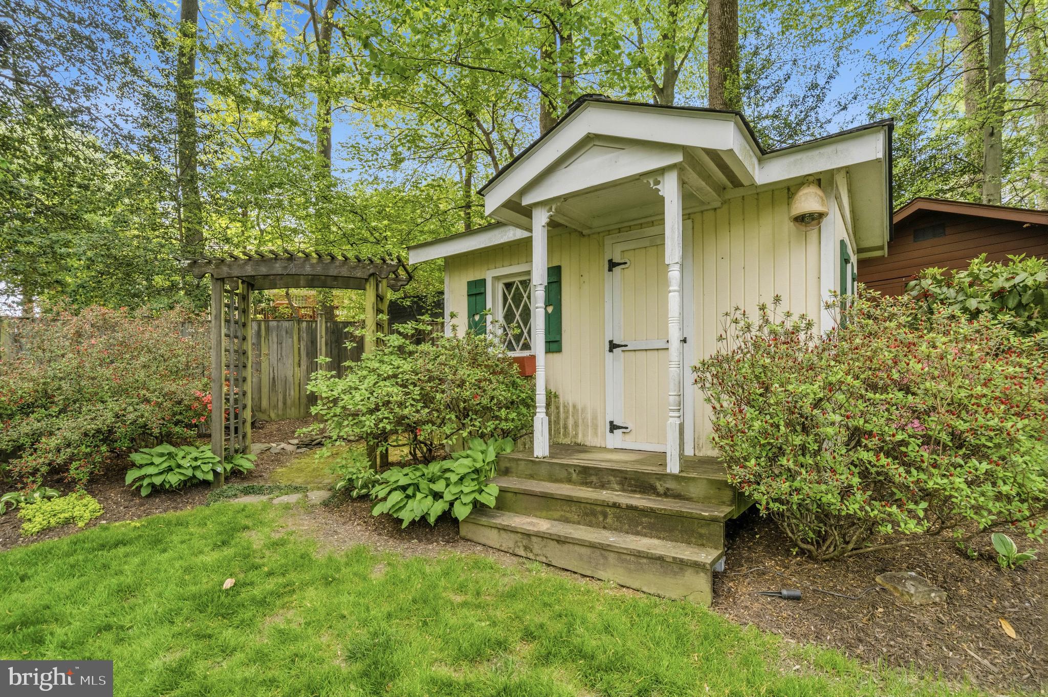 8927 Cromwell Drive Springfield, VA 22151 - Photo 14 of 20 a front view of a house with a garden
