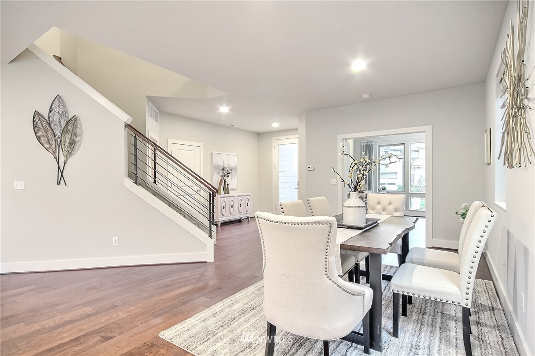 5113 Northeast 11th Place Renton, WA 98059 - Photo 11 of 40 a dining room with furniture a rug and wooden floor