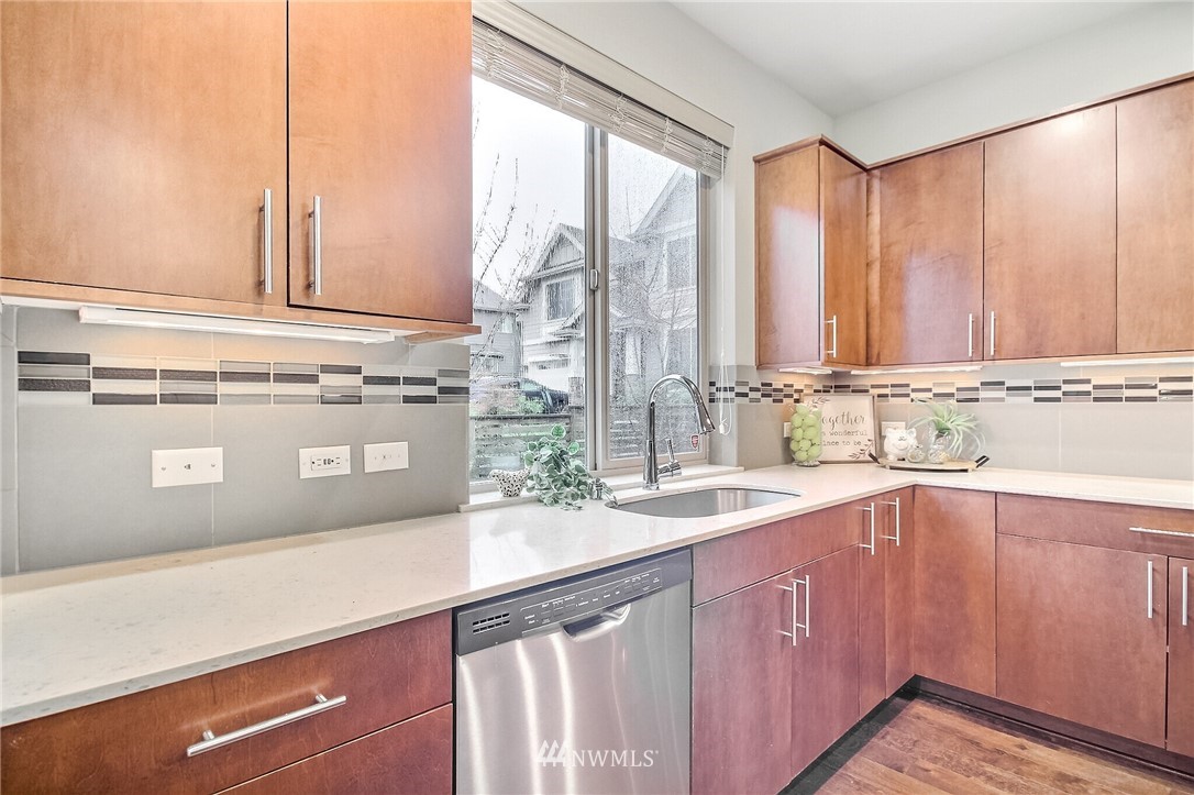 5113 Northeast 11th Place Renton, WA 98059 - Photo 14 of 40 a kitchen with stainless steel appliances a sink and a window