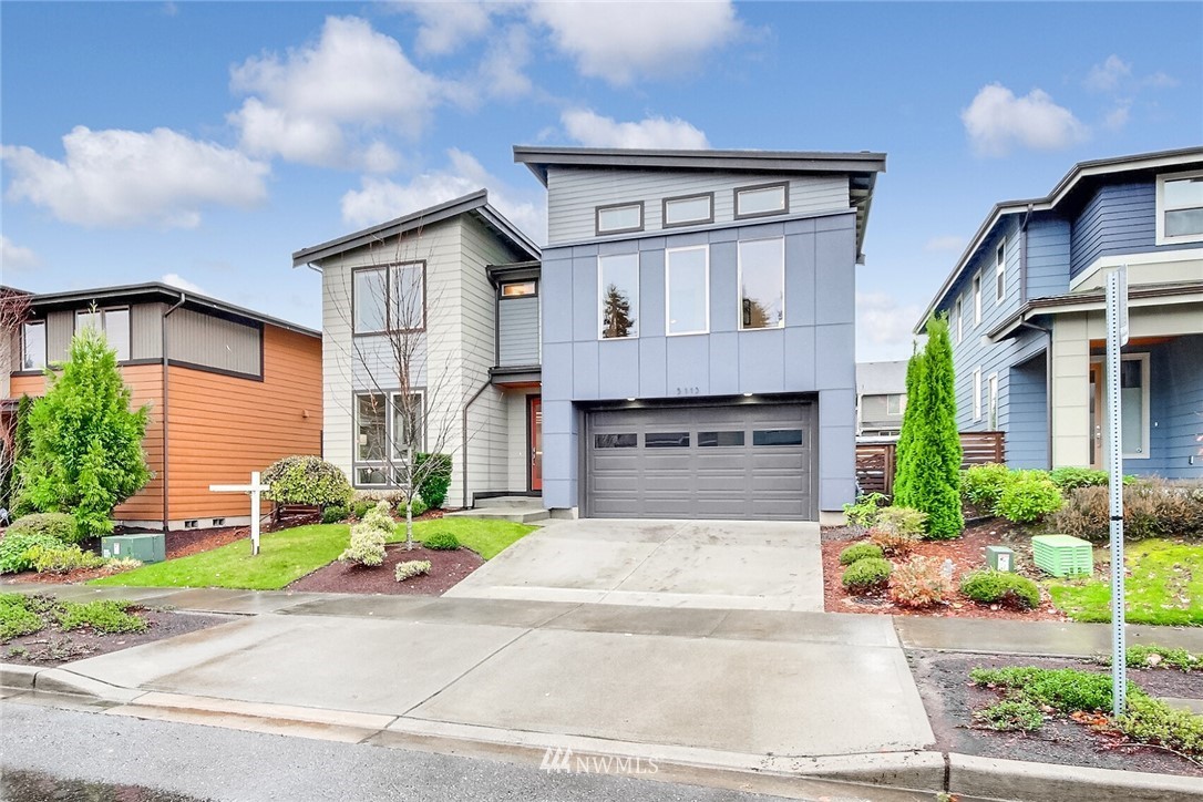 5113 Northeast 11th Place Renton, WA 98059 - Photo 2 of 40 a front view of a house with a yard and potted plants