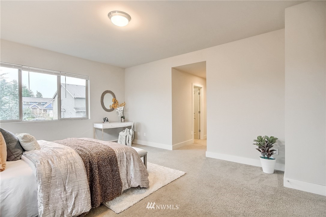5113 Northeast 11th Place Renton, WA 98059 - Photo 22 of 40 a bedroom with a bed and a large window