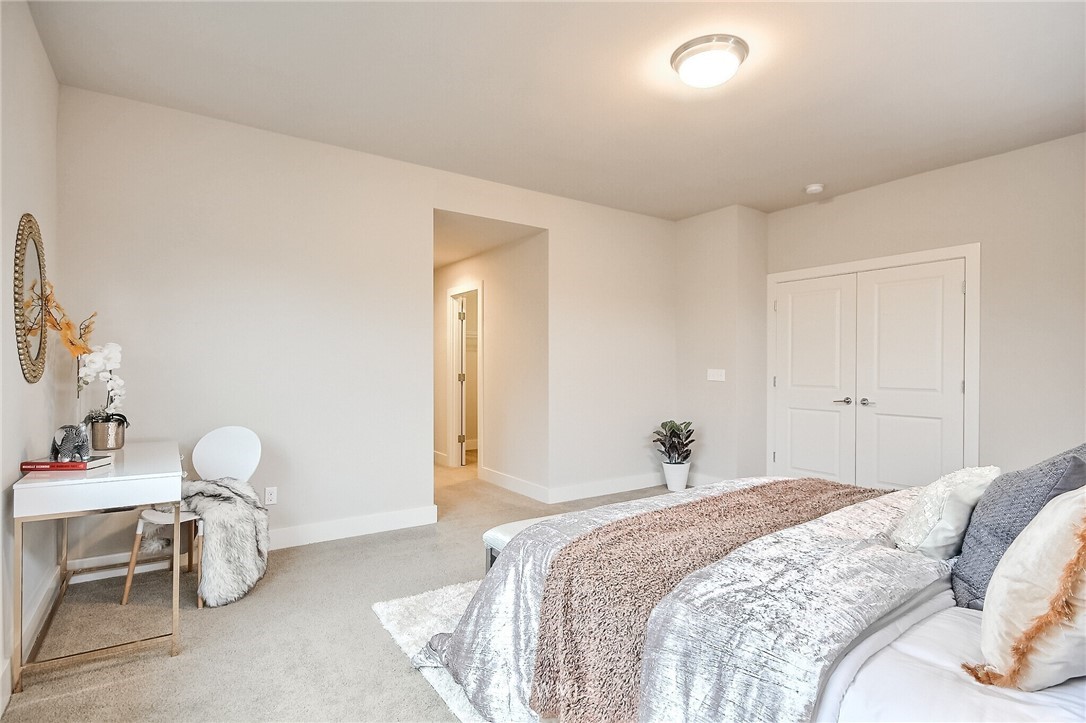 5113 Northeast 11th Place Renton, WA 98059 - Photo 23 of 40 a bedroom with a bed and a lamp