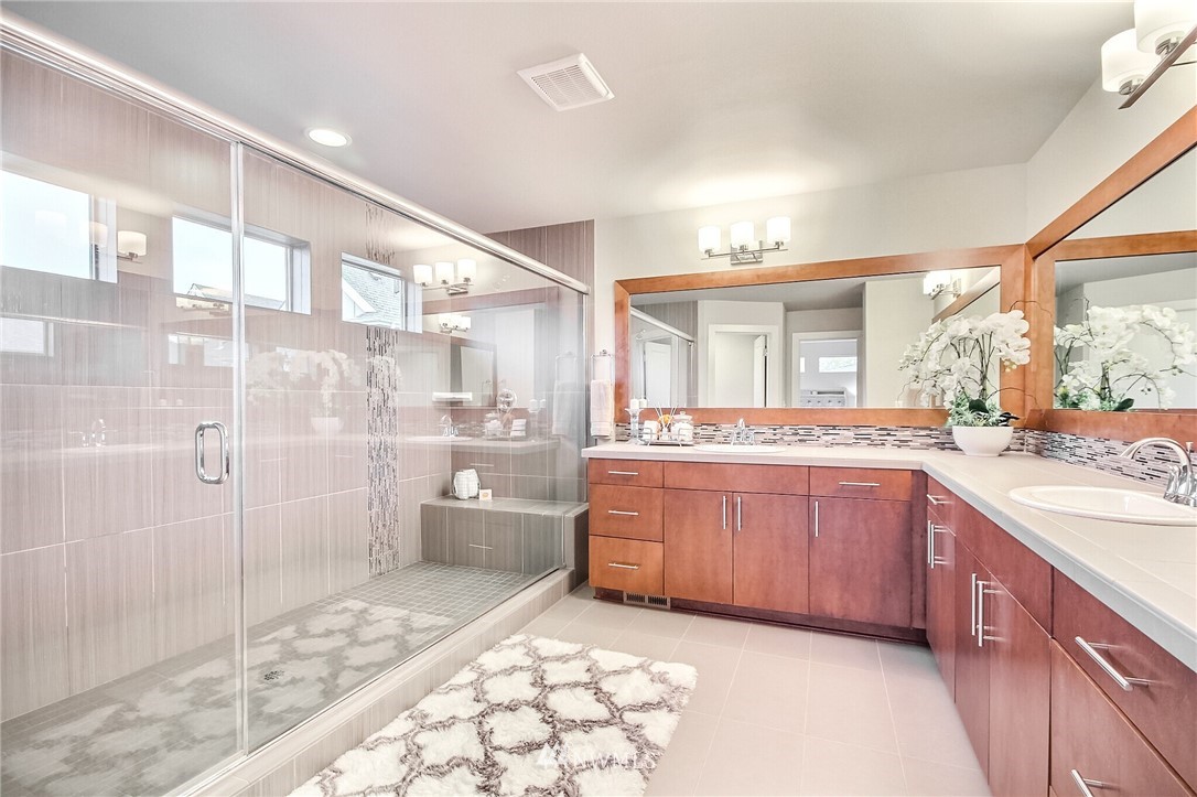 5113 Northeast 11th Place Renton, WA 98059 - Photo 24 of 40 a large bathroom with a glass door shower and sink