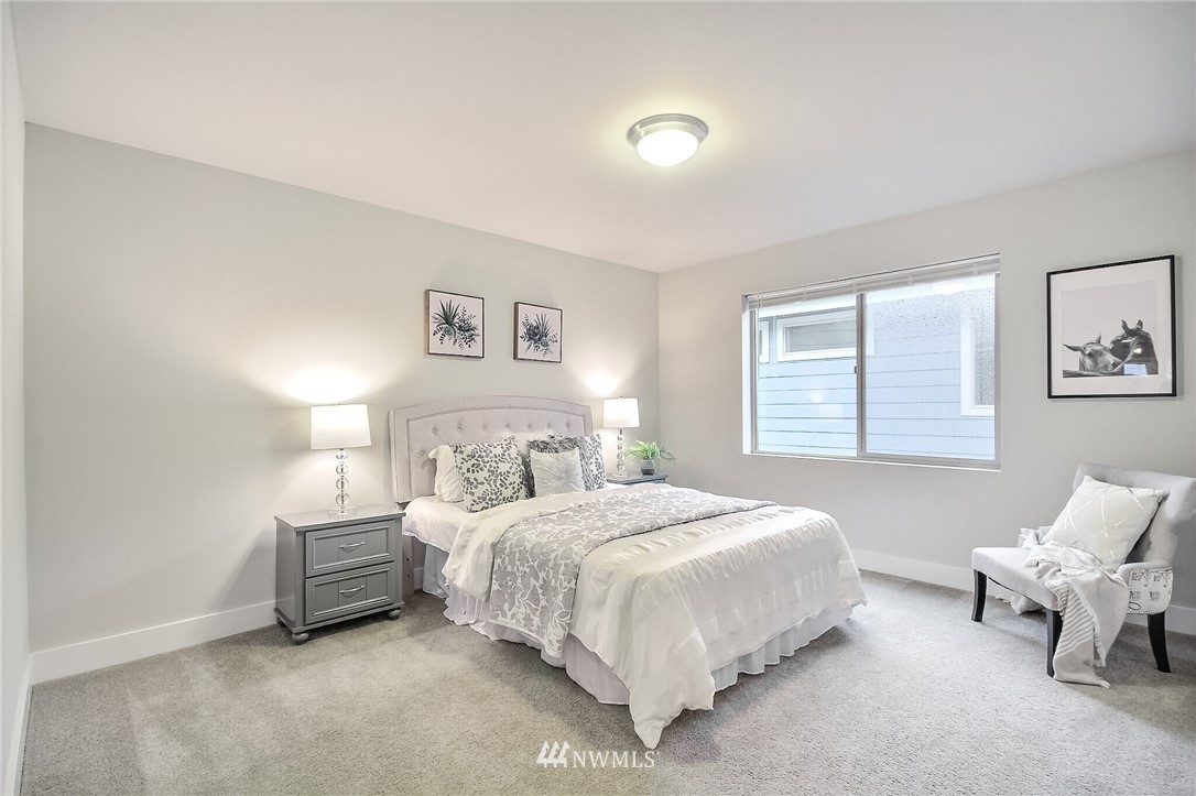 5113 Northeast 11th Place Renton, WA 98059 - Photo 28 of 40 a bedroom with a bed and a couch